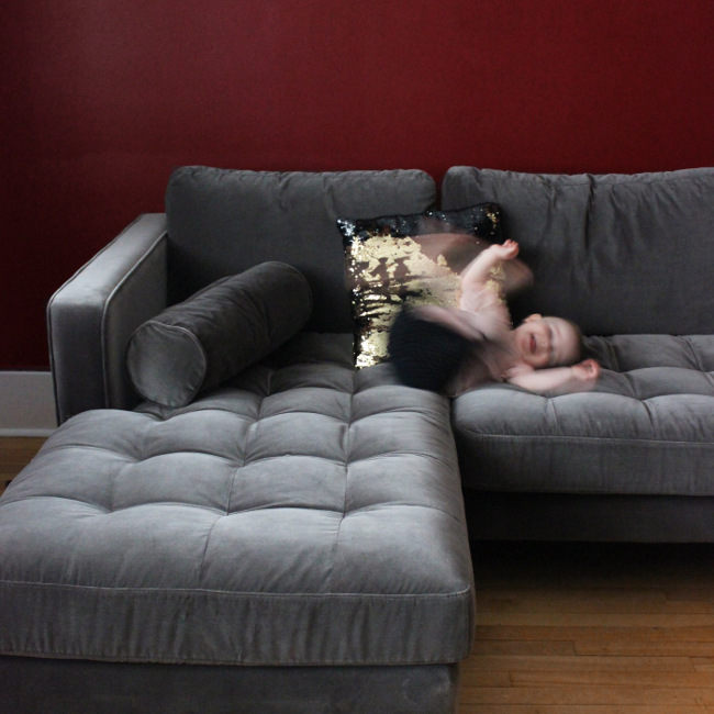 Gray Article Sven Sectional Sofa with a blurry toddler having fun.